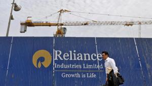 A man walks past an advertisement of Reliance Industries Limited at a construction site in Mumbai.(Reuters File Photo) A man walks past an advertisement of Reliance Industries Limited at a construction site in Mumbai.(Reuters File Photo)