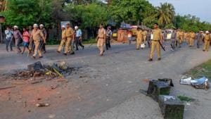 Security personnel walk past burnt ballot boxes lying on a road after miscreants ransacked at a polling station during panchayat polls at Rampur in South Dinajpur district of West Bengal, on Monday.(PTI) Security personnel walk past burnt ballot boxes lying on a road after miscreants ransacked at a polling station during panchayat polls at Rampur in South Dinajpur district of West Bengal, on Monday.(PTI)