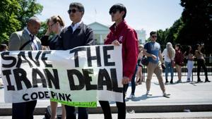 Protesters stand outside the White House in Washington, DC on May 8, as US President Donald Trump announces the United State's withdrawal from the Iran nuclear deal(AFP)