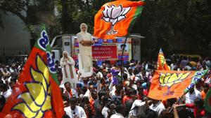 Supporters of the Bharatiya Janata Party (BJP) carry cut-out photographs of Prime Minister Narendra Modi and party president Amit Shah as they celebrate early leads for the party in the Karnataka state elections in Bangalore on May 15, 2018.(AP) Supporters of the Bharatiya Janata Party (BJP) carry cut-out photographs of Prime Minister Narendra Modi and party president Amit Shah as they celebrate early leads for the party in the Karnataka state elections in Bangalore on May 15, 2018.(AP)