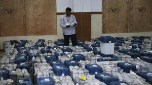 A polling official stands next to electronic voting machines in Bangalore. Counting of votes took an interesting turn late on Tuesday, with the BJP falling short of majority despite an impressive showing and the Congress reaching out to the JD(S) to keep PM Narendra Modi’s party at bay.(AP) A polling official stands next to electronic voting machines in Bangalore. Counting of votes took an interesting turn late on Tuesday, with the BJP falling short of majority despite an impressive showing and the Congress reaching out to the JD(S) to keep PM Narendra Modi’s party at bay.(AP)