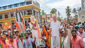 BJP workers hold cut-outs of PM Narendra Modi and BJP's chief ministerial candidate BS Yeddyurappa after Karnataka election results, in Chikmagalur on Tuesday.(PTI Photo) BJP workers hold cut-outs of PM Narendra Modi and BJP's chief ministerial candidate BS Yeddyurappa after Karnataka election results, in Chikmagalur on Tuesday.(PTI Photo)