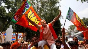 BJP supporters celebrate the party’s performance in the Karnataka assembly elections, in Bengaluru on Tuesday.(Reuters) BJP supporters celebrate the party’s performance in the Karnataka assembly elections, in Bengaluru on Tuesday.(Reuters)