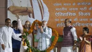 Prime Minister Narendra Modi (C) gestures after being presented a garland as (L-R) MP chief minister Shivraj Singh Chouhan, transport minister Nitin Gadkari, BJP president Amit Shah, home minister Rajnath Singh and foreign minister Sushma Swaraj look on at a ceremony after the Karnataka election results, at the BJP headquarters in New Delhi on May 15, 2018.(Vipin Kumar/HT Photo) Prime Minister Narendra Modi (C) gestures after being presented a garland as (L-R) MP chief minister Shivraj Singh Chouhan, transport minister Nitin Gadkari, BJP president Amit Shah, home minister Rajnath Singh and foreign minister Sushma Swaraj look on at a ceremony after the Karnataka election results, at the BJP headquarters in New Delhi on May 15, 2018.(Vipin Kumar/HT Photo)