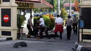 Police remove the bodies of attackers who were shot and killed at the entrance of a police station in Pekanbaru, Indonesia.(Antara Foto/ Retmon/ via Reuters) Police remove the bodies of attackers who were shot and killed at the entrance of a police station in Pekanbaru, Indonesia.(Antara Foto/ Retmon/ via Reuters)