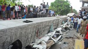 People look at the vehicles crushed under the flyover at the collapse site in Varanasi on Wednesday, a day after the mishap.(PTI Photo) People look at the vehicles crushed under the flyover at the collapse site in Varanasi on Wednesday, a day after the mishap.(PTI Photo)