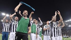 Gianluigi Buffon celebrates with teammates after Juventus won a seventh straight Serie A title after a goalless draw against AS Roma at the Stadio Olimpico on May 13, 2018. It is the 34th Scudetto in Juventus' history.(AFP)
