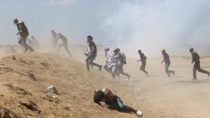 A Palestinian demonstrator reacts as others run from tear gas fired by Israeli forces during a protest marking the 70th anniversary of Nakba, at the Israel-Gaza border in the southern Gaza Strip May 15, 2018.(REUTERS File Photo) A Palestinian demonstrator reacts as others run from tear gas fired by Israeli forces during a protest marking the 70th anniversary of Nakba, at the Israel-Gaza border in the southern Gaza Strip May 15, 2018.(REUTERS File Photo)