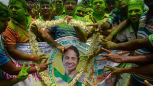 Trinamool Congress supporters celebrate with a poster of party chief and West Bengal chief minister Mamata Banerjee to celebrate their win in panchayat elections, in North 24 Parganas, on May17.(PTI Photo) Trinamool Congress supporters celebrate with a poster of party chief and West Bengal chief minister Mamata Banerjee to celebrate their win in panchayat elections, in North 24 Parganas, on May17.(PTI Photo)