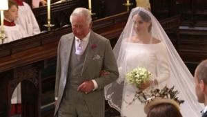 Meghan Markle walks down the aisle with Prince Charles for her wedding ceremony at St. George's Chapel in Windsor Castle in Windsor, near London, England.(AP) Meghan Markle walks down the aisle with Prince Charles for her wedding ceremony at St. George's Chapel in Windsor Castle in Windsor, near London, England.(AP)