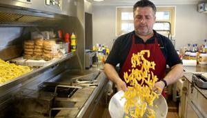 Fritkot owner Kemal Vucitrna tosses fries in a fries stand in Brussels, Belgium.(REUTERS) Fritkot owner Kemal Vucitrna tosses fries in a fries stand in Brussels, Belgium.(REUTERS)