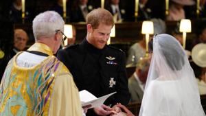 Prince Harry places the wedding ring on the finger of Meghan Markle in St George's Chapel at Windsor Castle during their wedding service, conducted by the Archbishop of Canterbury Justin Welby in Windsor, Britain, May 19, 2018.(REUTERS) Prince Harry places the wedding ring on the finger of Meghan Markle in St George's Chapel at Windsor Castle during their wedding service, conducted by the Archbishop of Canterbury Justin Welby in Windsor, Britain, May 19, 2018.(REUTERS)