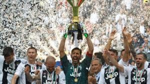 Gianluigi Buffon lifts the Serie A trophy as Juventus players celebrate winning the league at the Allianz Stadium in Turin on Saturday.(Reuters)