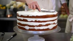 Owner of Violet Bakery in Hackney, east London, Claire Ptak puts finishing touches to the wedding cake of Britain's Prince Harry and US actress Meghan Markle in the kitchens of Buckingham Palace in London.(AFP) Owner of Violet Bakery in Hackney, east London, Claire Ptak puts finishing touches to the wedding cake of Britain's Prince Harry and US actress Meghan Markle in the kitchens of Buckingham Palace in London.(AFP)