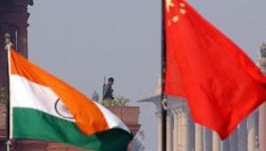 An Indian paramilitary officer is framed by an Indian (L) and Chinese (R) flags as he stands guard near the presidential palace in New Delhi, 12 January 2002.(AFP File Photo) An Indian paramilitary officer is framed by an Indian (L) and Chinese (R) flags as he stands guard near the presidential palace in New Delhi, 12 January 2002.(AFP File Photo)