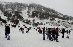 Tourists enjoy the view of snow covered hills around the Changu Lake after fresh snowfall, some 40 kilometres from Gangtok, in Sikkim.(PTI File Photo) Tourists enjoy the view of snow covered hills around the Changu Lake after fresh snowfall, some 40 kilometres from Gangtok, in Sikkim.(PTI File Photo)