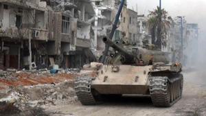 A handout picture released by the official Syrian Arab News Agency (SANA) on May 10, 2018 shows a Syrian army tank advancing through a street in al-Hajar al-Aswad as they push against the Islamic State (IS) group in the area on the southern outskirts of the capital Damascus.(AFP) A handout picture released by the official Syrian Arab News Agency (SANA) on May 10, 2018 shows a Syrian army tank advancing through a street in al-Hajar al-Aswad as they push against the Islamic State (IS) group in the area on the southern outskirts of the capital Damascus.(AFP)