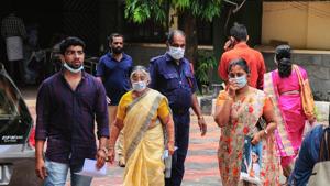 Hospital staff and family members of the patients admitted at the Kozhikode Medical College wear safety masks as a precautionary measure after the 'Nipah' virus outbreak, in Kozhikode, on Monday.(PTI Photo)
