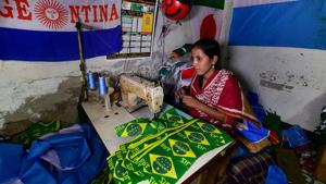 This photograph taken on May 17, 2018 shows a Bangladeshi worker sewing flags for FIFA World Cup football playing nations in Narayanganj, on the outskirts of Dhaka, ahead of Russia 2018.(AFP) This photograph taken on May 17, 2018 shows a Bangladeshi worker sewing flags for FIFA World Cup football playing nations in Narayanganj, on the outskirts of Dhaka, ahead of Russia 2018.(AFP)