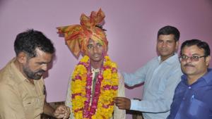 People welcome farmer's son Vishvendra Singh who scored 99.40% in Class 12 of RBSE exam on Thursday.(HT PHOTO) People welcome farmer's son Vishvendra Singh who scored 99.40% in Class 12 of RBSE exam on Thursday.(HT PHOTO)