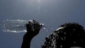 A man pours water on his face during a hot summer day.(AP File Photo) A man pours water on his face during a hot summer day.(AP File Photo)