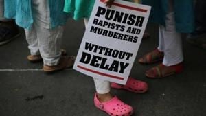 A protestor stands with a placard during a protest near the Parliament in New Delhi.(AP File Photo) A protestor stands with a placard during a protest near the Parliament in New Delhi.(AP File Photo)