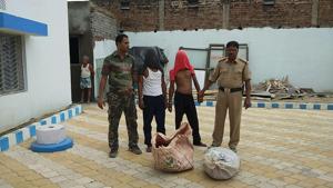 Manglu Khan and Sadekul Khan (faces covered) with Shamshergunj police on Friday.(HT Photo) Manglu Khan and Sadekul Khan (faces covered) with Shamshergunj police on Friday.(HT Photo)