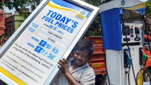 A petrol pump employee adjusts the price board at a fuel station as fuel prices record the highest-ever, in Kolkata, on Friday.(PTI) A petrol pump employee adjusts the price board at a fuel station as fuel prices record the highest-ever, in Kolkata, on Friday.(PTI)