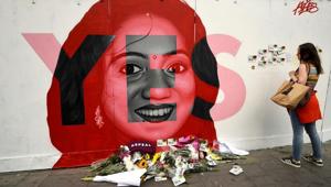 A woman looks at a new mural of Savita Halappanavar with flowers placed beneath it put up on the day of the Abortion Referendum on liberalising abortion laws in Dublin, Ireland May 25, 2018.(REUTERS) A woman looks at a new mural of Savita Halappanavar with flowers placed beneath it put up on the day of the Abortion Referendum on liberalising abortion laws in Dublin, Ireland May 25, 2018.(REUTERS)