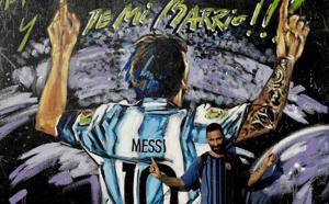 In this April 18, 2018 photo, Alejandro Daniel Fernandez poses for a photo by a mural of his childhood friend, Lionel Messi, that reads in Spanish "From my neighborhood!" in La Bajada, Rosario, Argentina. Fernandez said Messi's family had always helped him, including living with the family for a while, and that he remains friends with Lionel and his brother who all play soccer together when in town.(AP) In this April 18, 2018 photo, Alejandro Daniel Fernandez poses for a photo by a mural of his childhood friend, Lionel Messi, that reads in Spanish "From my neighborhood!" in La Bajada, Rosario, Argentina. Fernandez said Messi's family had always helped him, including living with the family for a while, and that he remains friends with Lionel and his brother who all play soccer together when in town.(AP)