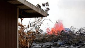 As a volcanic fissure spurts molten rock into the air, lava slowly approaches a home on Nohea Street in the Leilani Estates near Pahoa, Hawaii, on May 27, 2018.(REUTERS) As a volcanic fissure spurts molten rock into the air, lava slowly approaches a home on Nohea Street in the Leilani Estates near Pahoa, Hawaii, on May 27, 2018.(REUTERS)