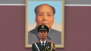 A paramilitary policeman stands guard before a giant portrait of late Chinese Chairman Mao Zedong at Tiananmen Gate. Mao continues to be deeply revered in China.(REUTERS File) A paramilitary policeman stands guard before a giant portrait of late Chinese Chairman Mao Zedong at Tiananmen Gate. Mao continues to be deeply revered in China.(REUTERS File)