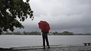 A man stands by the sea as it drizzles in Kochi in Kerala on May 28, 2018.(AP) A man stands by the sea as it drizzles in Kochi in Kerala on May 28, 2018.(AP)