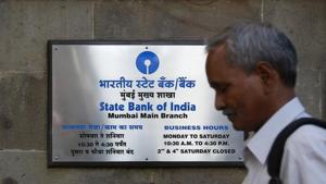 A man walks past the signboard displayed at the State Bank of India main branch in Mumbai.(Reuters File Photo) A man walks past the signboard displayed at the State Bank of India main branch in Mumbai.(Reuters File Photo)