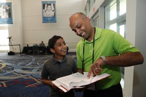 Dr. Balu Natarajan, right, poses for a photograph with his son Atman at the Scripps National Spelling Bee competition in Oxon Hill, Maryland.(AP Photo) Dr. Balu Natarajan, right, poses for a photograph with his son Atman at the Scripps National Spelling Bee competition in Oxon Hill, Maryland.(AP Photo)