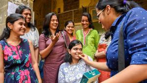 Vanshika Joshi, a disabled student who scored 71% in the Higher Secondary Certificate examination, congratulated by other toppers at SP College in Pune on Wednesday.(SANKET WANKHADE/HT PHOTO) Vanshika Joshi, a disabled student who scored 71% in the Higher Secondary Certificate examination, congratulated by other toppers at SP College in Pune on Wednesday.(SANKET WANKHADE/HT PHOTO)
