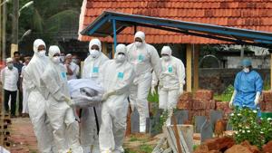 Doctors and relatives wearing protective gear carry the body of a victim, who lost his battle against Nipah virus, during his funeral at a burial ground in Kozhikode.(REUTERS File) Doctors and relatives wearing protective gear carry the body of a victim, who lost his battle against Nipah virus, during his funeral at a burial ground in Kozhikode.(REUTERS File)