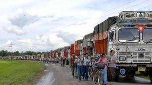 Schoolchildren and others walk past empty trucks parked in a row, waiting to be escorted by police to Assam to ferry supplies to Manipur, on the outskirts of Imphal.(HT File Photo) Schoolchildren and others walk past empty trucks parked in a row, waiting to be escorted by police to Assam to ferry supplies to Manipur, on the outskirts of Imphal.(HT File Photo)