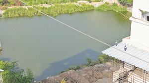 Debris was dumped near the pond just two days after the residents planted saplings to protect the water body.(Bachchan Kumar/ Hindustan Times) Debris was dumped near the pond just two days after the residents planted saplings to protect the water body.(Bachchan Kumar/ Hindustan Times)