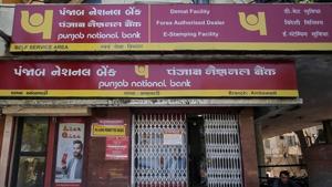 A man reads a newspaper outside a branch of Punjab National Bank (PNB) in Ahmedabad.(Reuters File Photo) A man reads a newspaper outside a branch of Punjab National Bank (PNB) in Ahmedabad.(Reuters File Photo)