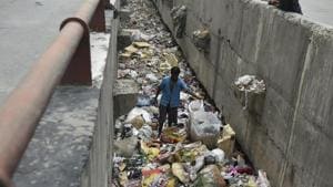 A man scavenges through a drain full of discarded plastic at Geeta colony in Delhi. As Delhi observes yet another World Environment Day, it is yet to get its act together when it comes to handling solid waste.(Ravi Choudhary/HT File Photo) A man scavenges through a drain full of discarded plastic at Geeta colony in Delhi. As Delhi observes yet another World Environment Day, it is yet to get its act together when it comes to handling solid waste.(Ravi Choudhary/HT File Photo)