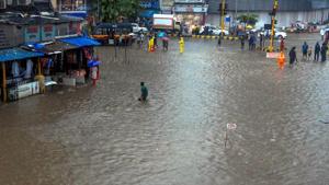 People wade through a water logged street following heavy monsoon showers in Mumbai on Saturday, June 9, 2018.(PTI Photo) People wade through a water logged street following heavy monsoon showers in Mumbai on Saturday, June 9, 2018.(PTI Photo)