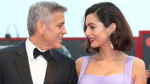 George Clooney, left, and his wife Amal Clooney pose for photographers upon arrival at the premiere of the film Suburbicon during the 74th edition of the Venice Film Festival in Venice, Italy.(Joel Ryan/Invision/AP) George Clooney, left, and his wife Amal Clooney pose for photographers upon arrival at the premiere of the film Suburbicon during the 74th edition of the Venice Film Festival in Venice, Italy.(Joel Ryan/Invision/AP)