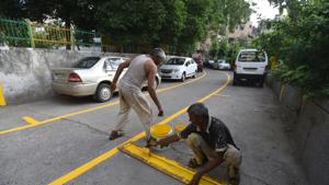 A labourer paints a line on a road for making a boundary for parking at Lajpat Nagar II in New Delhi , India, on Monday, June 11, 2018.(HT Photo) A labourer paints a line on a road for making a boundary for parking at Lajpat Nagar II in New Delhi , India, on Monday, June 11, 2018.(HT Photo)