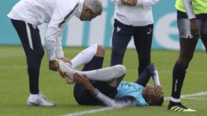 France's Kylian Mbappe grimaces after being injured during a training session ahead of the FIFA World Cup 2018.(AP) France's Kylian Mbappe grimaces after being injured during a training session ahead of the FIFA World Cup 2018.(AP)