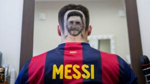 A football fan sports a hair tattoo showing the portrait of Argentinian football player Lionel Messi at a hair salon in Novi Sad, Serbia, on June 10, 2018.(AFP)