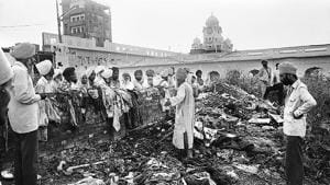 Devotees look at the damage inflicted on the Golden Temple in Amritsar after the Operation Bluestar in 1984.(HT File)