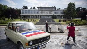 Visitors take pictures near a Yugoslav era popular car Zastava 101.(AFP) Visitors take pictures near a Yugoslav era popular car Zastava 101.(AFP)