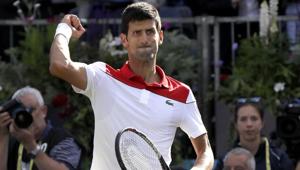 Novak Djokovic of Serbia celebrates winning his match against Grigor Dimitrov of Bulgaria during their singles tennis match at the Queen's Club in London on Thursday.(AP)