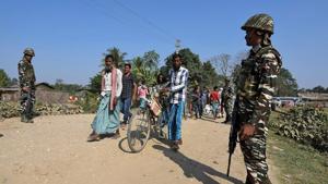 Villagers walk past Central Reserve Police Force personnel patrolling a road ahead of the publication of the first draft of the National Register of Citizens in the Juria village of Nagaon district in Assam, in 2017.(File photo) Villagers walk past Central Reserve Police Force personnel patrolling a road ahead of the publication of the first draft of the National Register of Citizens in the Juria village of Nagaon district in Assam, in 2017.(File photo)